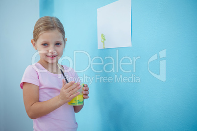 Cute girl holding glass with paint