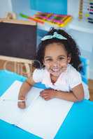 Cute girl writing on notebook