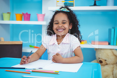 Cute girl writing on notebook