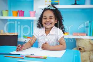 Cute girl writing on notebook