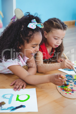 Cute girls painting letters