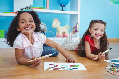 Cute girls painting letters