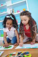 Cute girls painting with their fingers