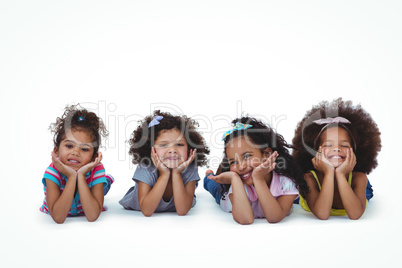 Cute girls laying on the floor with head on hands Cute girls laying on the floor with head on hands