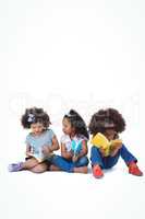 Cute girls sitting on floor reading books