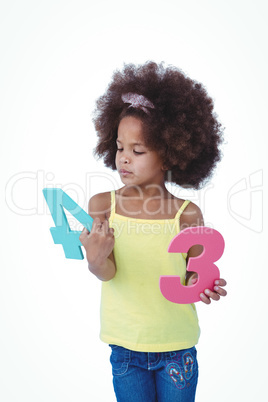 Standing girl looking at sponge numbers