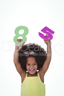 Cute girl raising hands holding sponge numbers