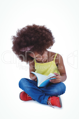 Cute girl sitting on the floor holding book