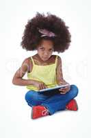 Cute girl sitting on floor using tablet