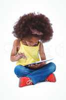 Cute girl sitting on the floor using tablet