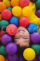 Cute smiling boy in sponge ball pool
