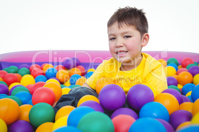 Cute smiling boy in sponge ball pool