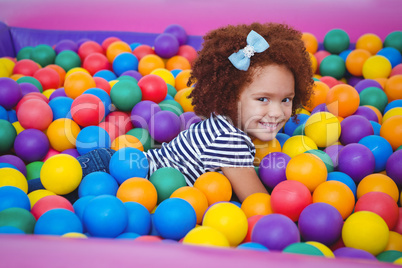 Cute smiling girl in sponge ball pool