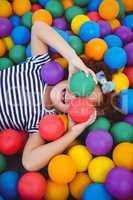 Cute smiling girl in sponge ball pool