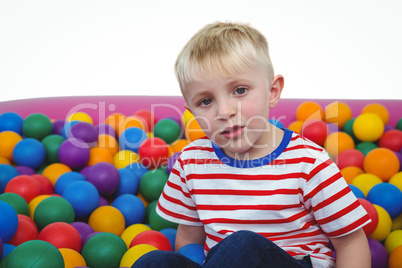 Cute smiling boy in sponge ball pool