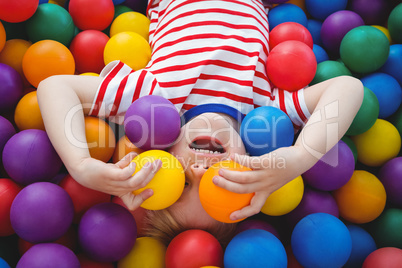 Cute smiling boy in sponge ball pool