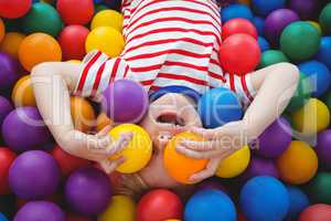 Cute smiling boy in sponge ball pool