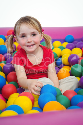 Cute smiling girl in sponge ball pool