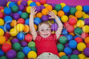 Cute smiling girl in sponge ball pool