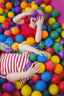 Cute smiling kids in sponge ball pool