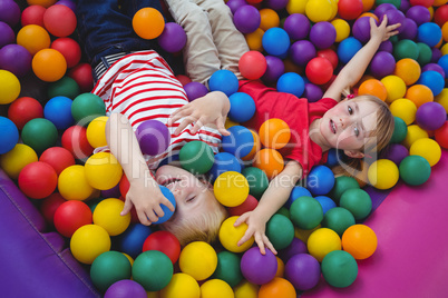 Cute smiling kids in sponge ball pool