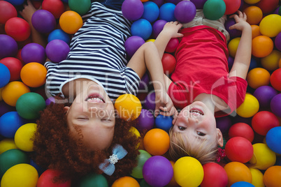 Cute smiling girls in sponge ball pool