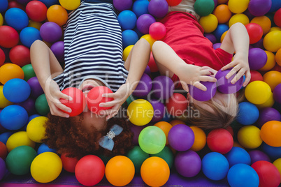 Cute smiling girls in sponge ball pool
