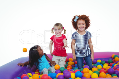 Cute smiling girls in sponge ball pool