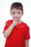 Standing boy using magnifying glass