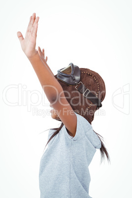 Side view of girl with outstretched arms pretending to be pilot