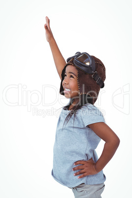Side view of girl with outstretched arm pretending to be pilot