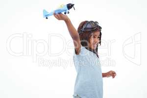 Smiling girl playing with toy airplane