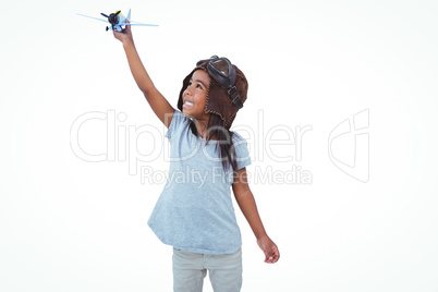 Smiling girl playing with toy airplane