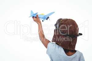 Standing girl playing with toy airplane