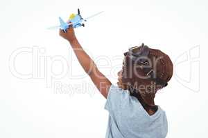 Standing girl playing with toy airplane