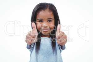 Smiling girl showing thumbs to camera