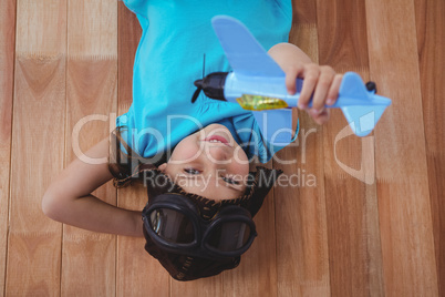 Smiling girl playing with toy airplane