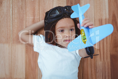 Smiling girl playing with toy airplane