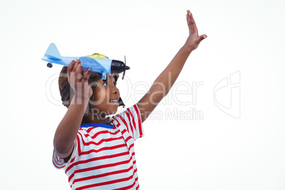 Smiling boy playing with toy airplane