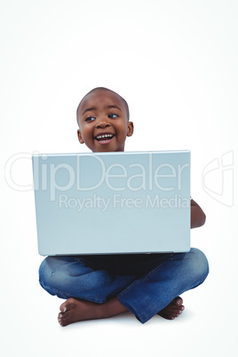 Sitting boy using laptop
