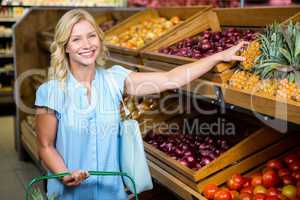 Smiling woman taking pineapple