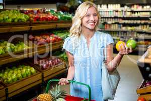 Smiling woman holding apples