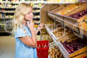 Thoughtful woman looking at onions