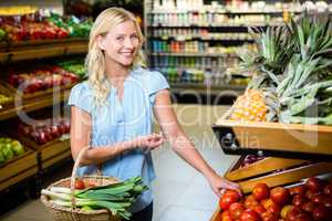 Smiling woman taking tomatoes