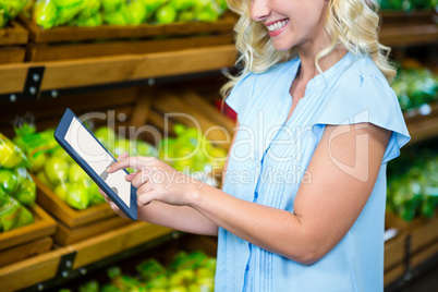 Smiling woman using tablet