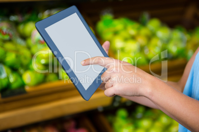 Womans hand using tablet