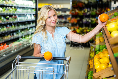 Smiling woman holding oranges