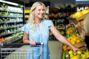 Smiling woman taking lemon