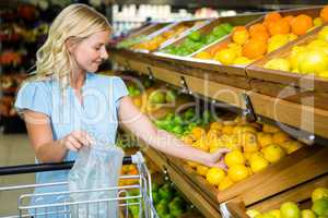 Smiling woman taking oranges