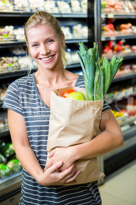 Beautiful woman standing with grocery bag